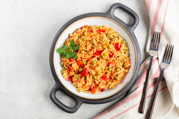 Djuvec rice - traditional balkan dish. Rice cooked with red bell pepper, tomato, peas and paprika.