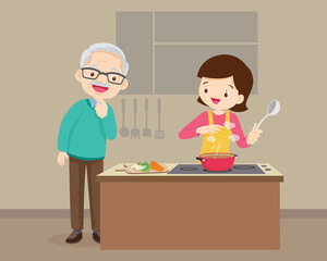 elderly man looking to woman cooking in kitchen