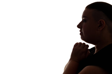 Praying woman. God blessing. Hope faith. Profile portrait of scared chubby overweight female silhouette asking for help forgiveness isolated on white copy space background. © golubovy
