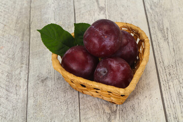 Plum heap in the wooden basket