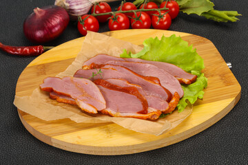 Sliced smoked duck breast served salad