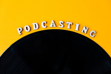 Podcasting lettering and vinyl record album in minimalistic style on yellow background. Millenial....