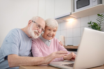 Senior couple having a video call and smiling