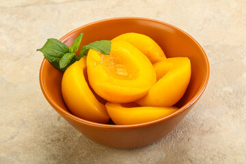 Sweet ripe canned peaches with mint