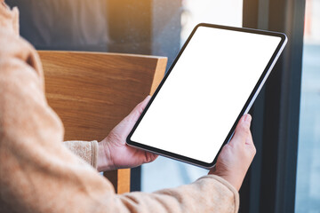 Mockup image of a woman holding digital tablet with blank white desktop screen