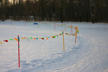multi-colored flags of the ski track fence