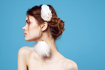 woman fluffy earrings bright makeup cropped view blue background