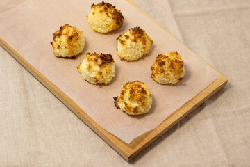 Homemade coconut macaroons coconut meringue cookies, traditional German Christmas cookies Kokosmakronen, craft paper