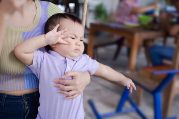 Fototapeta na wymiar Little boy 1 year old baby on blur background. cute child portrait authentic asian.