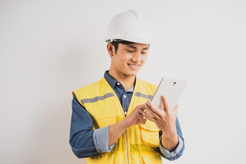 Asian construction engineer reading the technical drawing