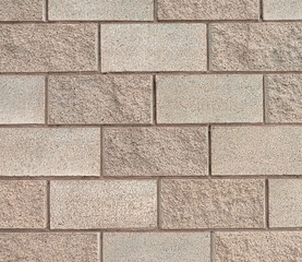 Wall with beige brick background