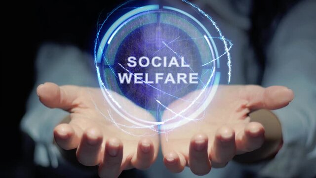 Female hands show a round conceptual hologram with text Social welfare. Unrecognizable woman in ashen white on a black background with future holographic technology