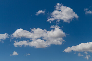 Naklejka na ściany i meble White clouds on the blue sky.