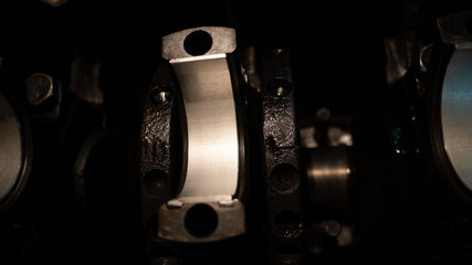 Fototapeta premium The car parts lie on the internal combustion engine. Close-up of connecting rods on the crankshaft. Car spare parts. Car engine motor repair