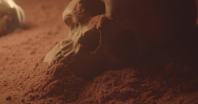 Skull in sand cave with fire