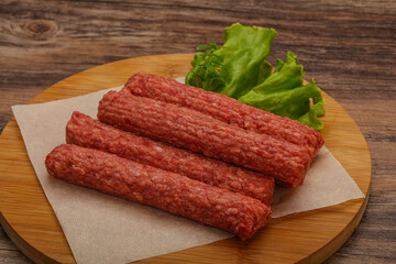 Raw beef sausages with spices