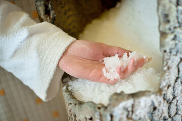 Picture of bowl full of crushed ice and hand with ice