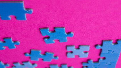 scattered puzzle pieces on colored background