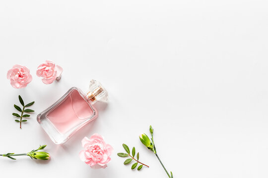 Transparent perfume with flowers and leaves. Flat lay, overhead view