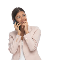 beautiful young girl talking on the phone and looking up dreaming