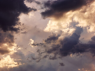 Sunset light in cloudy sky
