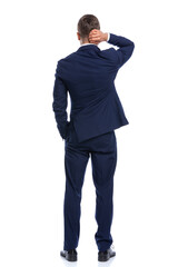 Fototapeta premium confused elegant guy holding hand in pocket and scratching head