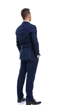 back view of elegant young businessman holding hands in pockets