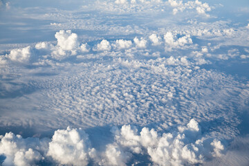 Fototapeta premium Aerial view of Blue sky and Cloud Top view from airplane window,Nature background. Sky and clouds.