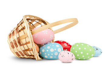 basket with scattered easter eggs on isolated white background