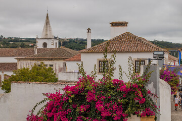 OBIDOS, PORTUGAL - 08-09-2020 : Souvenir shops and colorful narrow streets of the medieval portuguese city of Óbidos, a tourist attraction in central Portugal. famous destination for its architecture