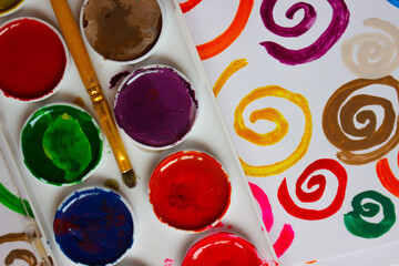 Pattern of colored painted spirals, background from watercolor paints and gouache