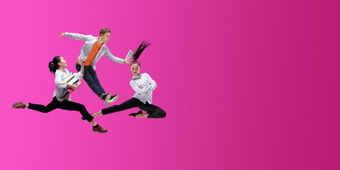 Fototapeta na wymiar Strawberry. Happy office workers jumping and dancing in casual clothes or suit isolated on gradient neon fluid background. Business, start-up, working open-space, motion, action concept. Creative