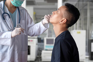 Fototapeta premium coronavirus COVID-19 test concept. doctor hand holding test tube, use cotton swab to collect nasal secretion sample from patient for corona virus infection test during epidemic in hospital laboratory