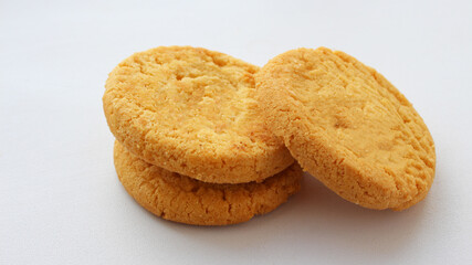 Group of round crispy cookies isolated on white background. Sweet cookies. Bakery products. Place for text, selective focus

