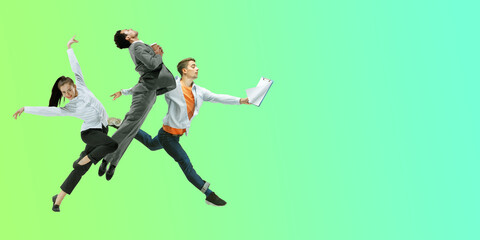 Green. Happy office workers jumping and dancing in casual clothes or suit isolated on gradient neon fluid background. Business, start-up, working open-space, motion, action concept. Creative collage.