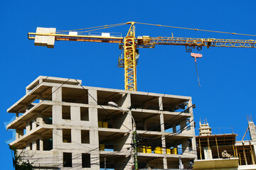 Construction site.  Self-erection crane near building. Industrial background.