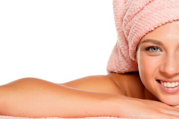 a young beautiful smiling woman with blue eyes posing with a towel on her head