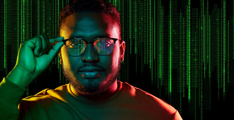 technology, cyberspace and programming concept - portrait of young african american man over binary code numbers on black background