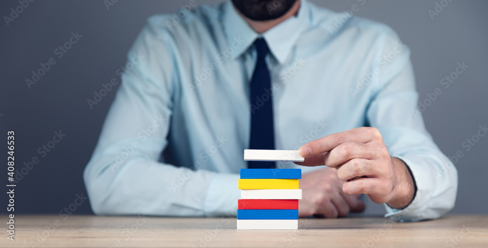 Canvas Prints man holding color wooden cube block