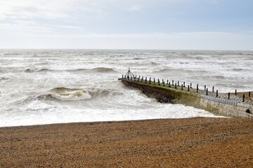 Hove Beach with waves crashing on a stormy day, Sussex, UK