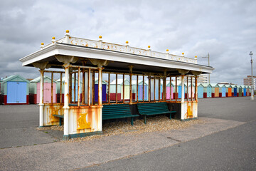 Brighton seafront shelter with beach huts, Sussex, UK