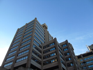 Genova, Italy - January 25, 2021: Modern construction in the city center of Genova, beautiful high skylines with grey and blue sky in the background in winter.