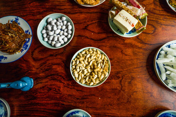 View of Vietnamese food for Tet holiday in spring, jam is traditional food and teapot set on lunar new year. Dried fruit and jam as tradition dessert - Mut Tet on wooden table.