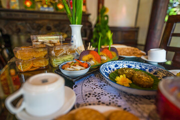 Naklejka na ściany i meble View of Vietnamese food for Tet holiday in spring, jam is traditional food and teapot set on lunar new year. Dried fruit and jam as tradition dessert - Mut Tet on wooden table.