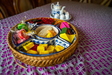 View of Vietnamese food for Tet holiday in spring, jam is traditional food and teapot set on lunar new year. Dried fruit and jam as tradition dessert - Mut Tet on wooden table.