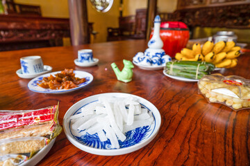 View of Vietnamese food for Tet holiday in spring, jam is traditional food and teapot set on lunar new year. Dried fruit and jam as tradition dessert - Mut Tet on wooden table.
