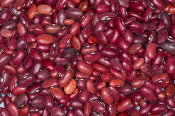 Raw red kidney beans close-up in selective focus, background