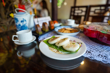 View of Vietnamese food for Tet holiday in spring, jam is traditional food and teapot set on lunar new year. Dried fruit and jam as tradition dessert - Mut Tet on wooden table.