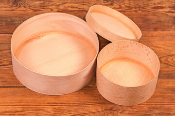 Round empty wooden boxes with removed lids on rustic table