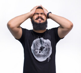 Headache concept. Young man showing how much his head hurts, experiencing pain, looking miserable...